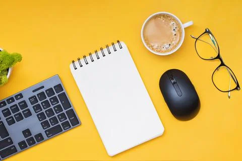 Keyboard, computer mouse and cofffe on yellow background Stock Photos