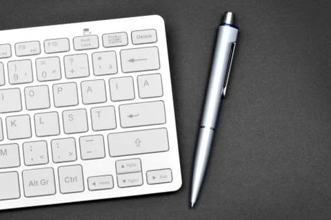 Keyboard computer with pen on black background Stock Photos