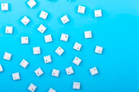 Keyboard keys isolated. White keyboard keys on blue background. Top view.  Stock Photos