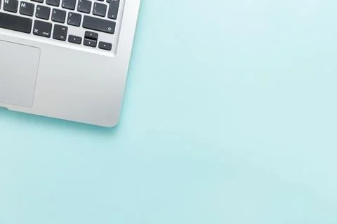 Keyboard laptop computer isolated on blue pastel desk background. Modern In.. Stock Photos