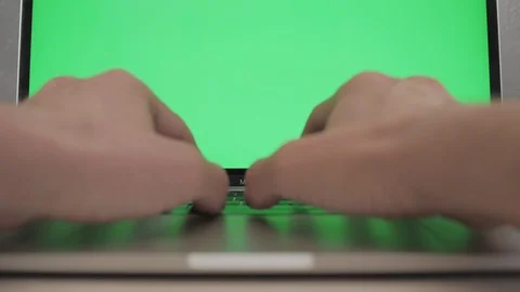 Keyboard of a laptop with a green screen Stock Footage 120594757