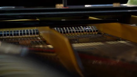 Keyboard mechanics of the piano while playing the instrument, close-up 動画素材 129575992