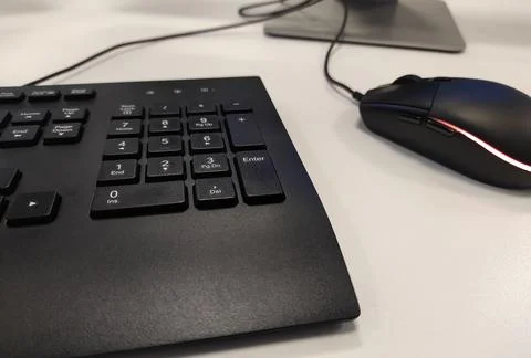 Keyboard with mouse black on white table Stock Photos