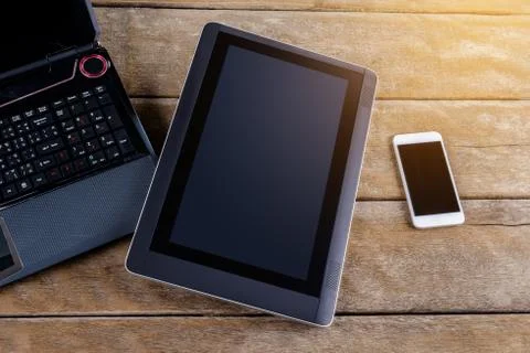 Keyboard of Notebook with smartphone and tablet pc on desk Stock Photos