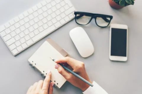 Keyboard, notepad, phone, hands Stock Photos