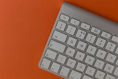 Keyboard On Orange Background Stockfoto's