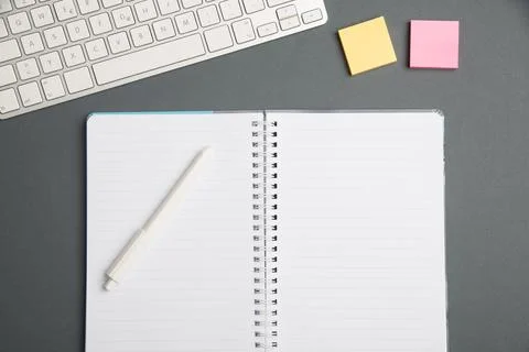 Keyboard Over A Table Beside A Notebook And Pens With Sticky Notes. Computer Stock Photos