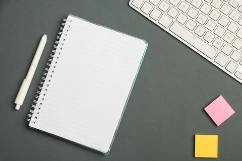 Keyboard Over A Table Beside A Notebook And Pens With Sticky Notes. Computer Stock Photos