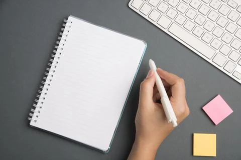 Keyboard Over A Table Beside A Notebook And Pens With Sticky Notes. Computer Stock Photos