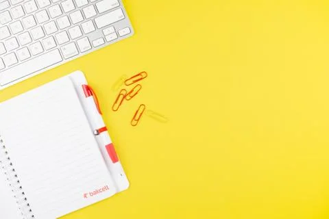 Keyboard, pen, notepad planner and colorful clips on yellow background. Flat  Stock Photos