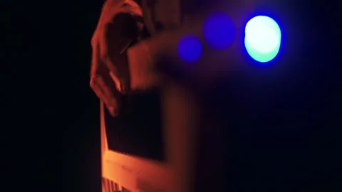 Keyboard player in red light in slow motion Stock Footage 318551900