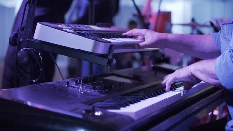 Keyboard player on stage with his band during a wedding party Stock Footage
