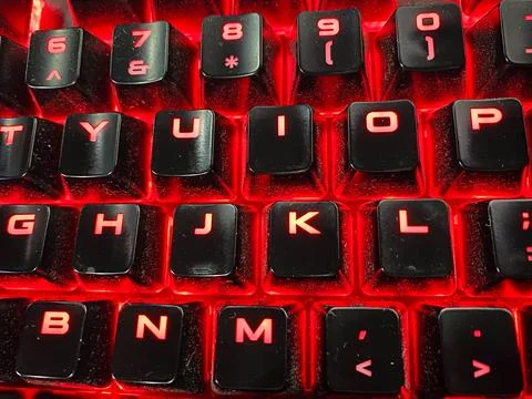 Keyboard with red letters, close-up. Computer keyboard background 库存照片