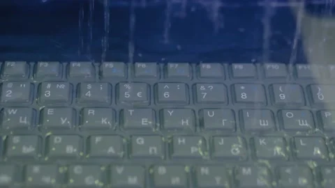 Keyboard of rugged laptop computer during water resistance test - close up Stock Footage 132877024