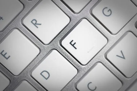 Keyboard - silver portable computer keyboard in IT department with letter F i Stock Photos