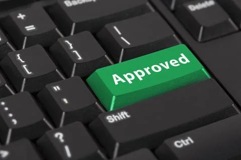 Keyboard with the word approved on green button. Stock Photos