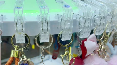 Keychains Hang On Numbered Clips Inside A Colorful Arcade Prize Machine Stock Footage 335394494