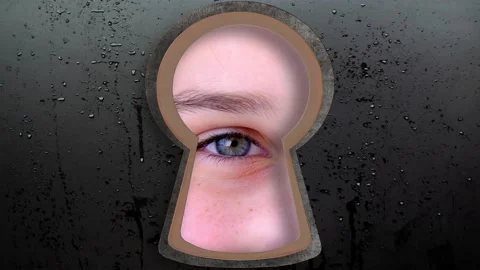 Keyhole hole with Human eye, Young child 10-12 years looking straight, covert Stock Footage 190011372