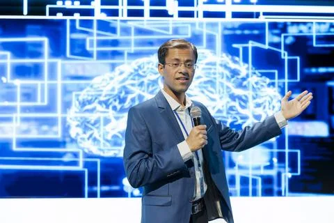 Keynote presenter points toward AI digital brain visualization Stock Photos