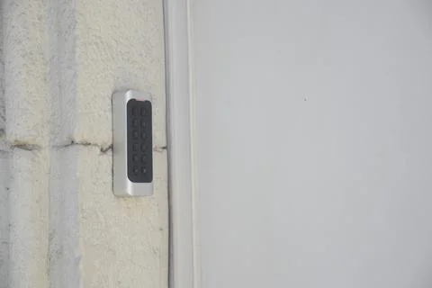 Keypad entry system mounted on a building's wall for secure access Stock Photos