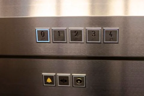 Keypad of a modern elevator decorated in gray polished aluminum Stock Photos