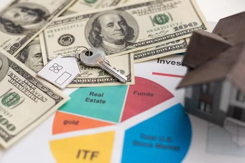 Keys and stack of dollars isolated on a white background Stock Photos