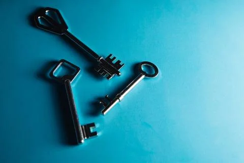 Keys on blue background. Minimal creative style Stock Photos