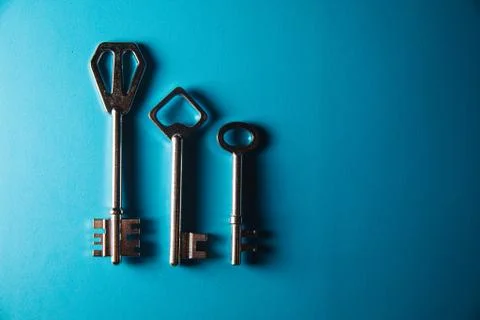 Keys on blue background. Minimal creative style Stock Photos