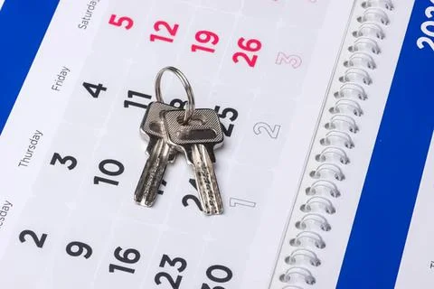 Keys on a calendar with a lock symbolizing security or planning Stock Photos
