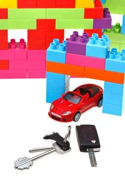Keys, model car, plastic block house door key, vehicle keys close up, red ... Fotos Stock
