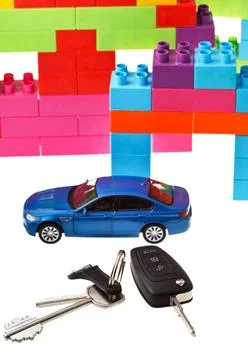 Keys, model car, plastic block house door key, vehicle keys close up, blue... Fotos Stock