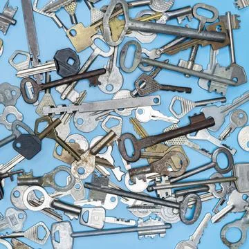 Keys set on blue background. Door lock keys and safes for property security a Stock Photos