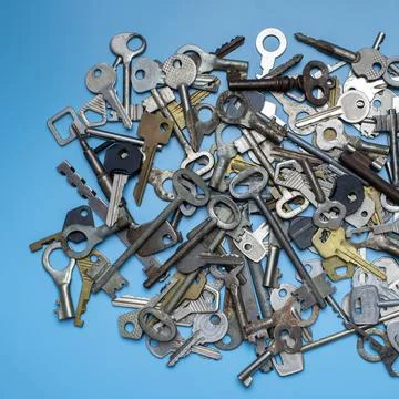 Keys set on blue background. Door lock keys and safes for property security a Stock Photos