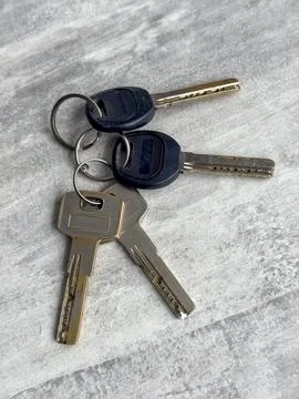 Keys sitting on a surface with a simple design and texture Stock Photos