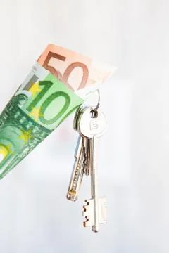 Keys in the wrapped currency notes 50 and 100 euros. Money and keys Stock Photos