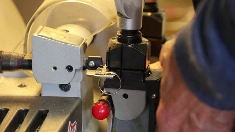 Keysmith key cutting service making new key Stock Footage 312313124