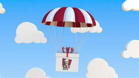 KFC logo on moving box moves under parachute. Editorial 3D rendering Illustrazione stock
