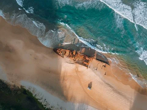 K'gari High angle aerial bird's eye drone view of the Maheno shipwreck on Stock Photos