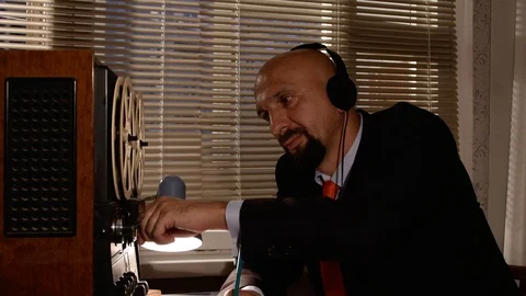 KGB agent overhears and records an important conversation on tape Stockbeeldmateriaal 114773086