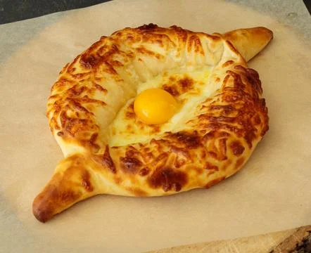 Khachapuri with egg and cheese. Flatbread with cheese. Close-up Stock Photos