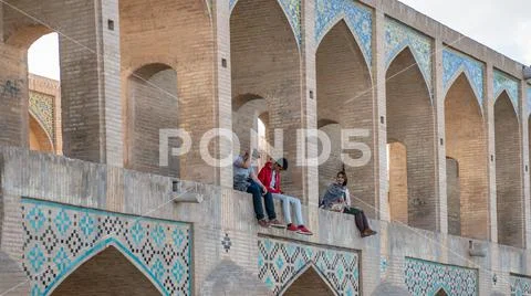 Khaju bridge over Zayandeh river with tourists and local people sitting and w Stock Photos