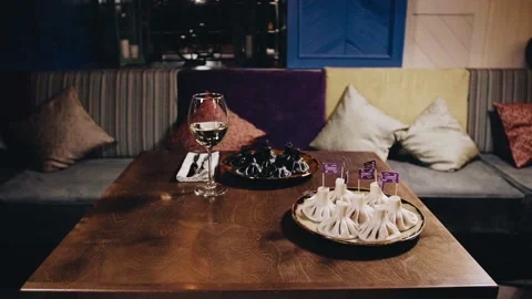 Khinkali on a beautiful table with wine Stock Footage 141482168