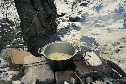 Khinkali on a fire in winter in the forest in the open air by the river Stock Photos
