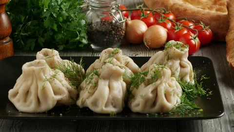 Khinkali served on a platter. Presentation of the dish. Camera drive along th Stock Footage 147870788