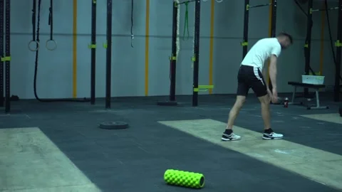 KHMELNYTSKYI, UKRAINE - MAY 9, 2020: Man stretching before training in crossfit Stock Footage 131329804