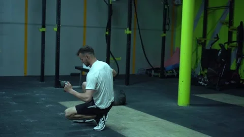 KHMELNYTSKYI, UKRAINE - MAY 9, 2020: Man stretching before training in crossfit Stock Footage 132724096
