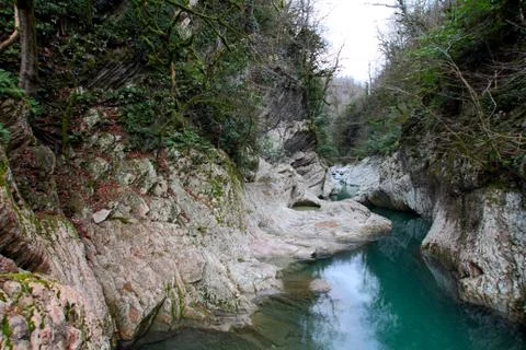 The Khosta river flows among karst banks. Stock Photos
