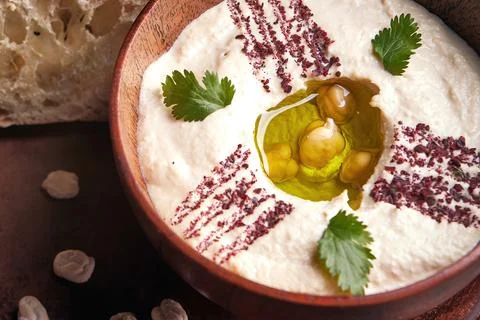 Khumus with bread on a clay plate. Close up Stock Photos