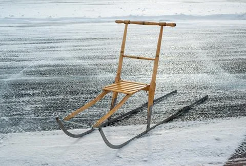Kick-sledge parked on the ice of a lake in winter sun Stock Photos