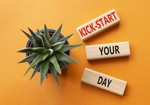 Kick-start your day team symbol. Wooden blocks with words Kick-start your d.. Fotos de archivo